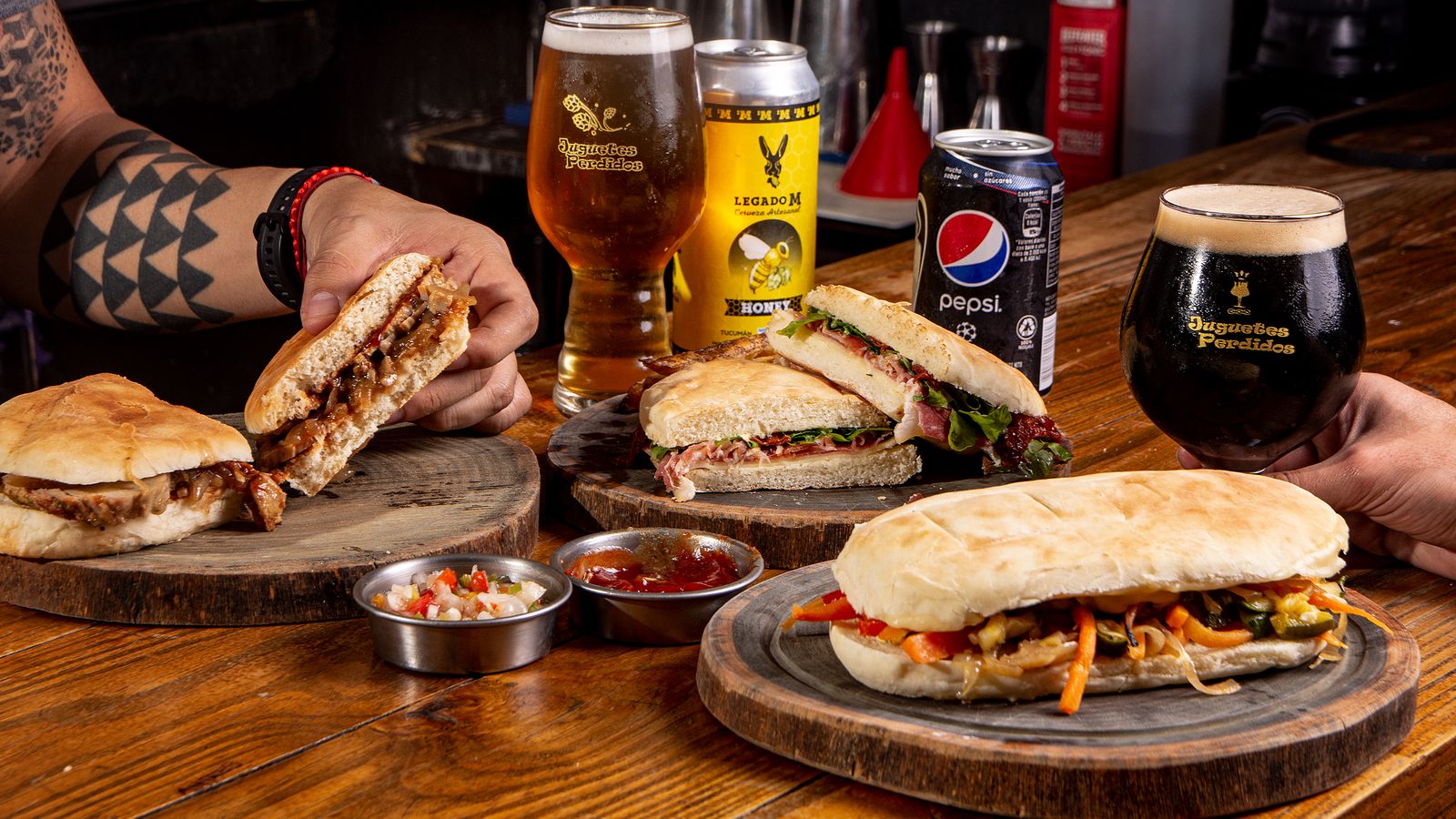 Pressed sandwiches and beers on a wooden table