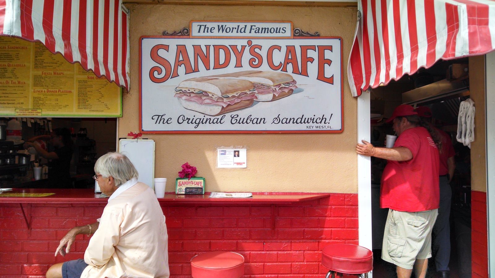 Customers at a walk-up Cuban sandwich cafe window in Key West